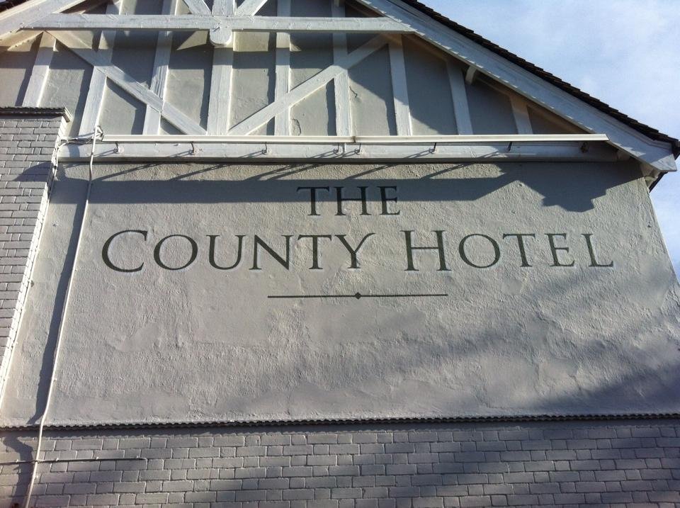 Our Bespoke Roman Letters . The County Hotel with border High level signage MEWP Harness access specialists