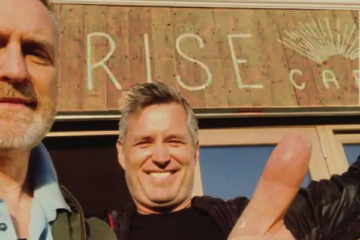 Rise Cafe sign painting Nick Garrett enjoying just done moment!