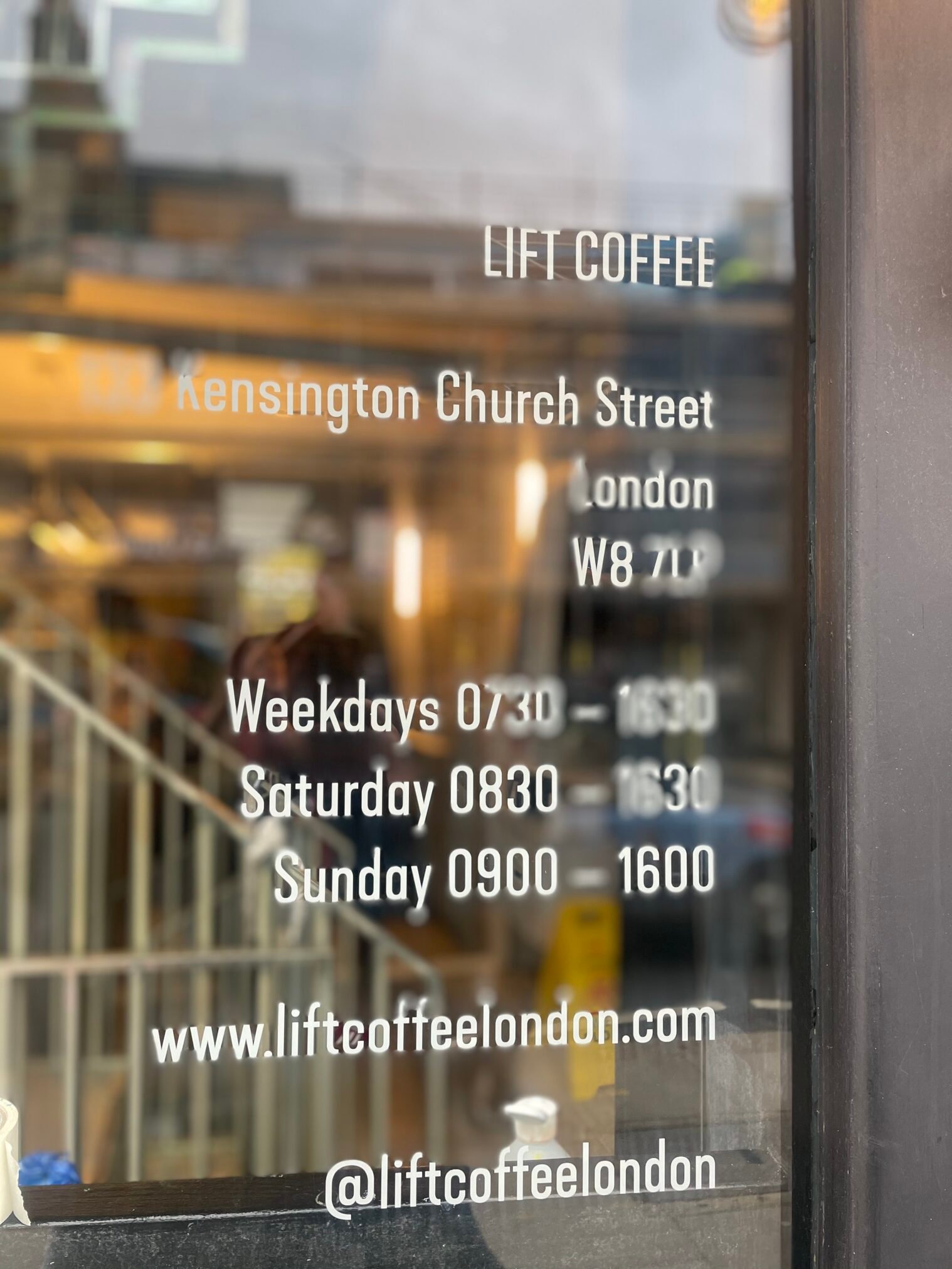 Shop POS signage, opening times on doors windows.