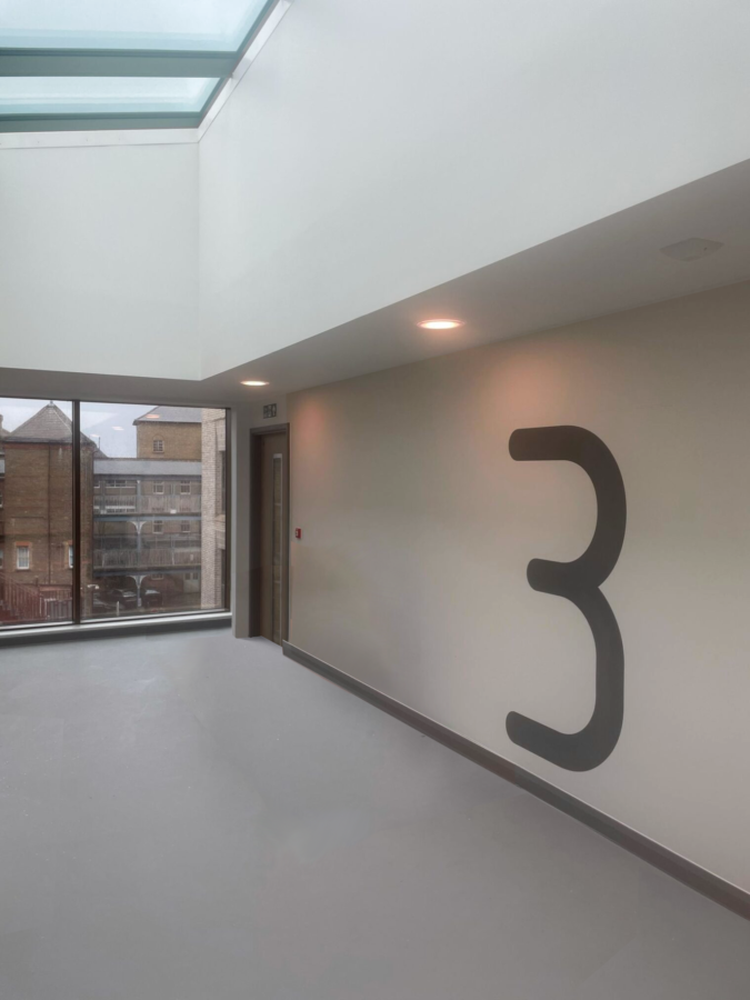 Hand Painted Wayfinding Camden Mental Health Lift Lobby wall numbers