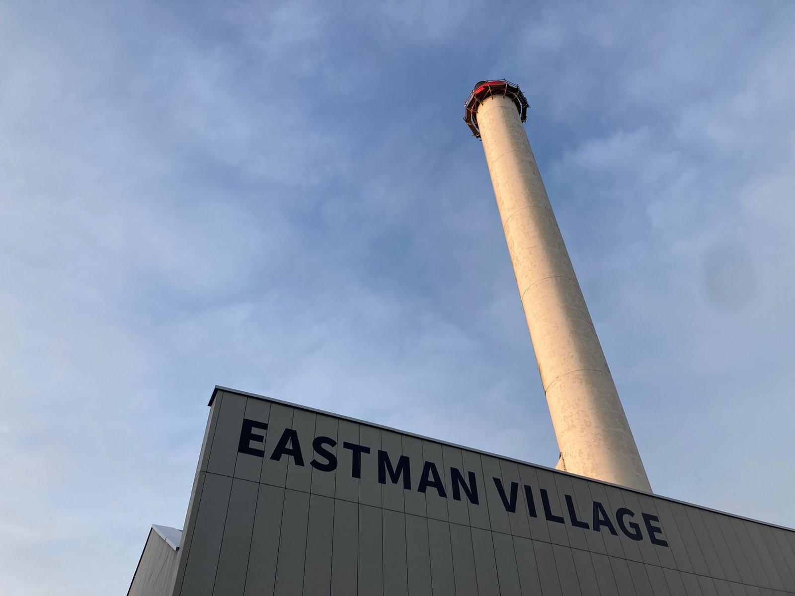Eastman Village KODAK factory sign by Seraina and Nick signwriters London, High Level Signage on rough render, cladding or brickwork. MEWP sign access NGS, Video NGS signwriting Roman O letter