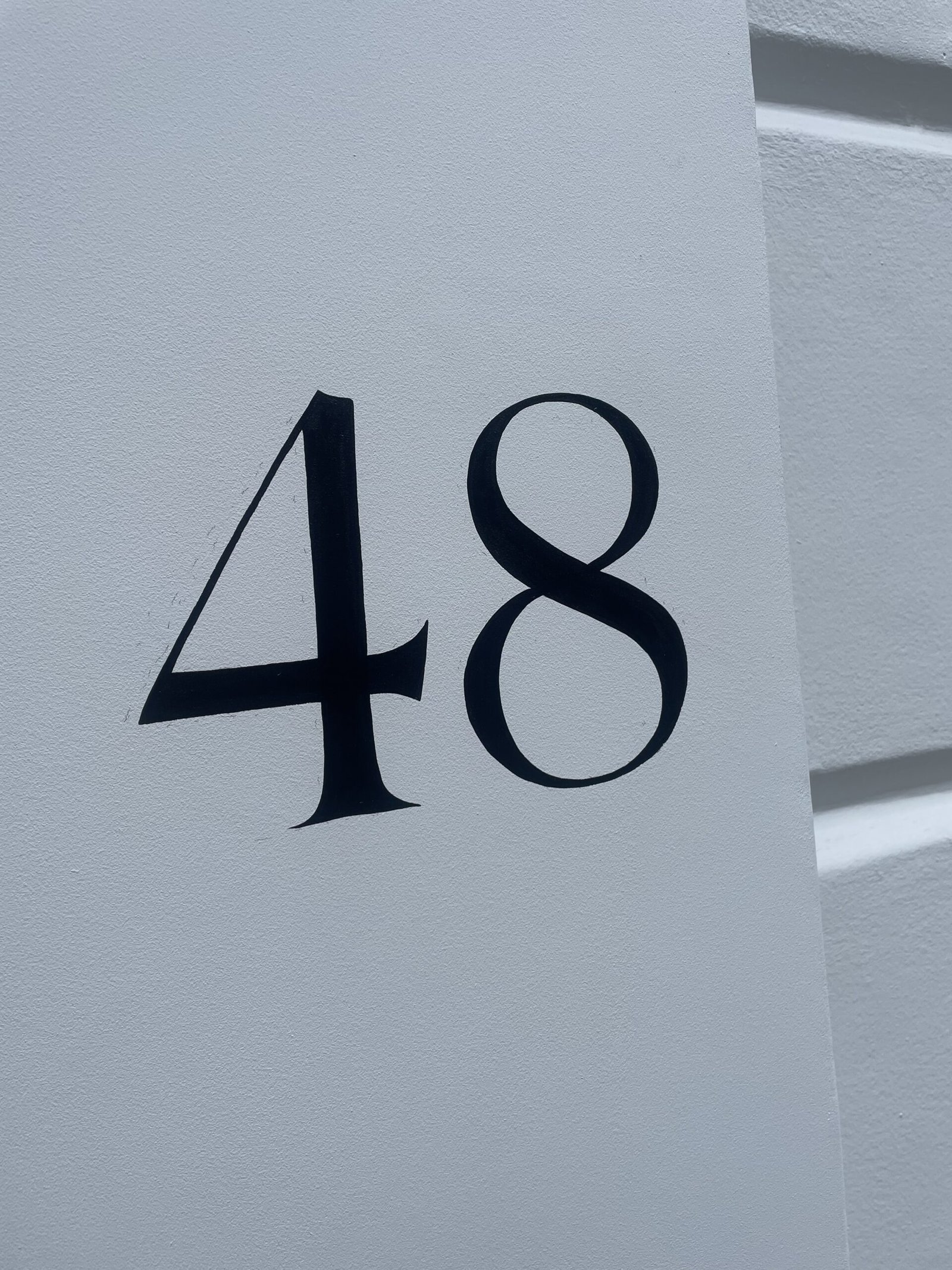 House numbers painted by hand on Pillars NGS London