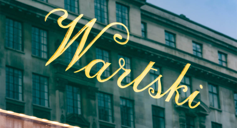 Gold cursive sign reading 'Wartski' on a glass gilding by NGS sign writers of London